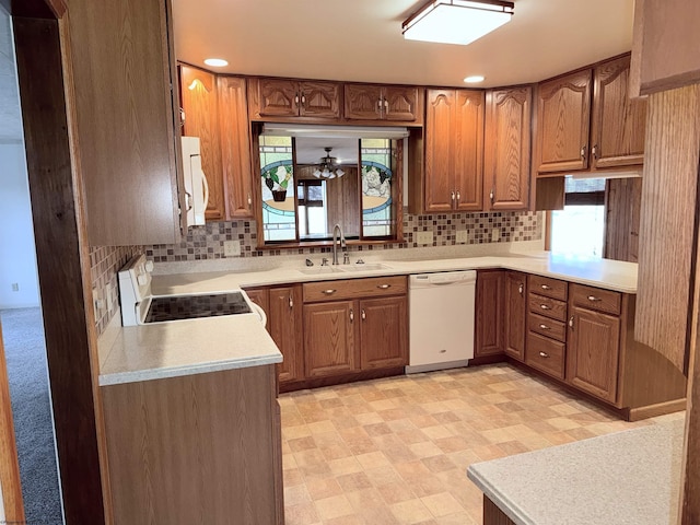 kitchen featuring sink, white appliances, and decorative backsplash