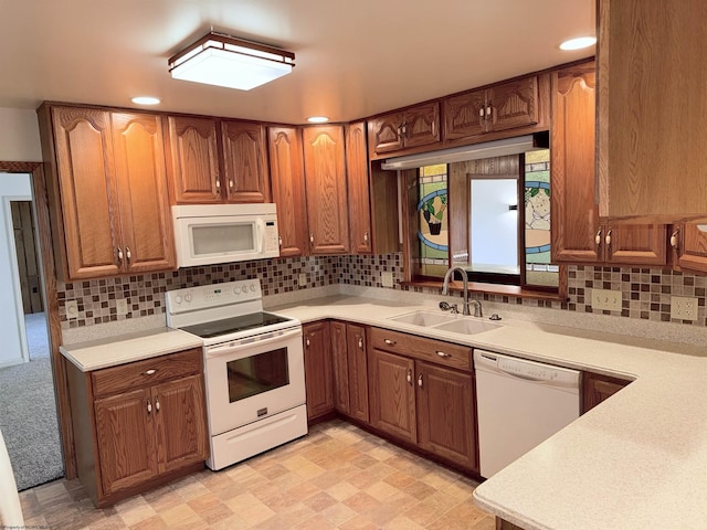 kitchen with sink, white appliances, and backsplash