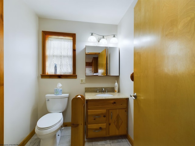 bathroom with vanity, tile patterned flooring, and toilet