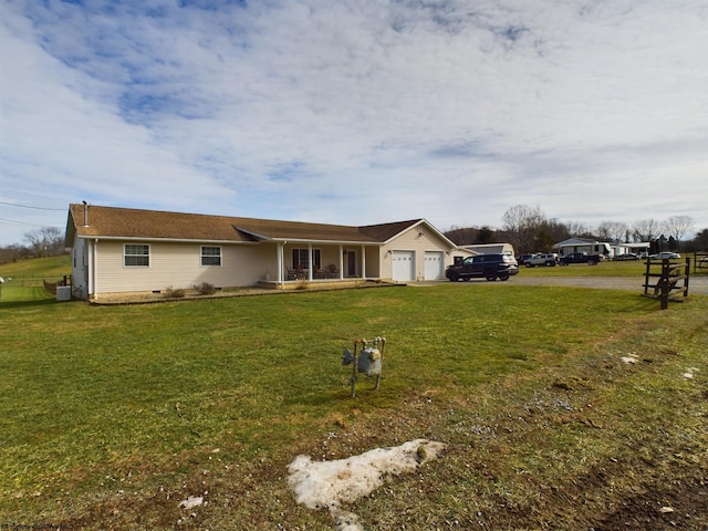 ranch-style home featuring a garage and a front yard