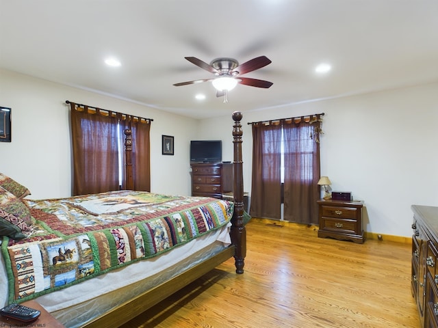 bedroom with ceiling fan and light wood-type flooring