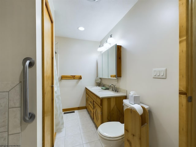 bathroom with vanity, tile patterned floors, and toilet