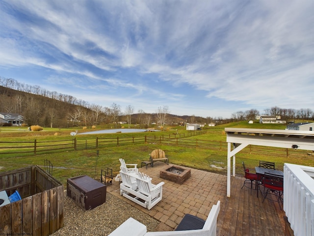 view of patio featuring an outdoor fire pit and a rural view