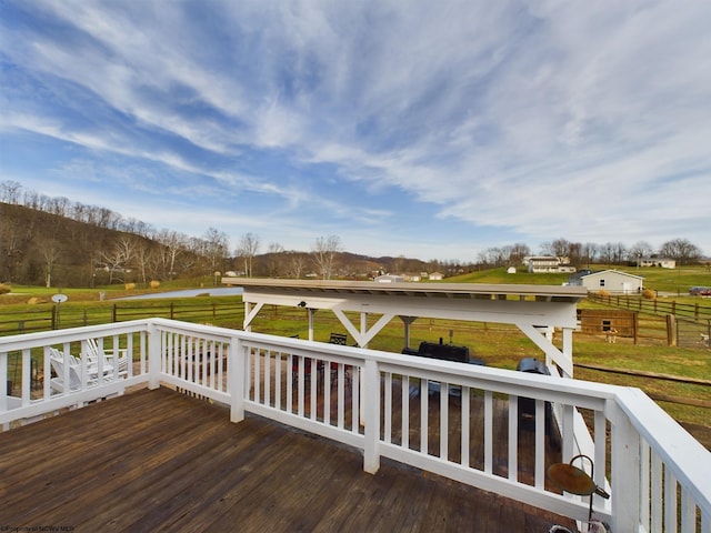 wooden terrace with a lawn