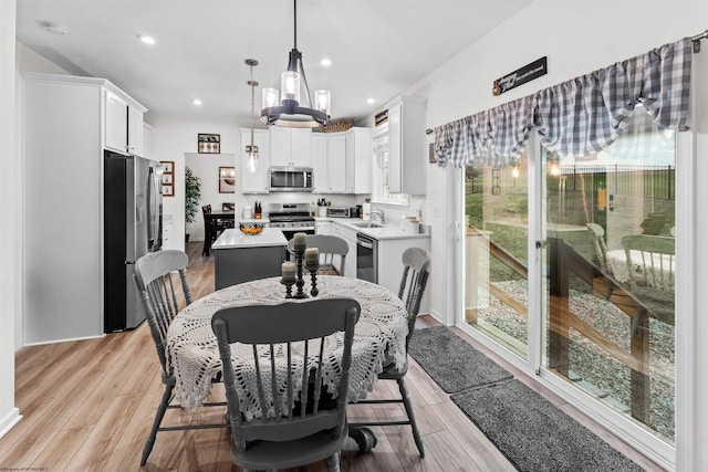 dining room featuring sink and light wood-type flooring