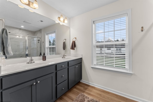 bathroom with vanity, a shower with door, and hardwood / wood-style floors