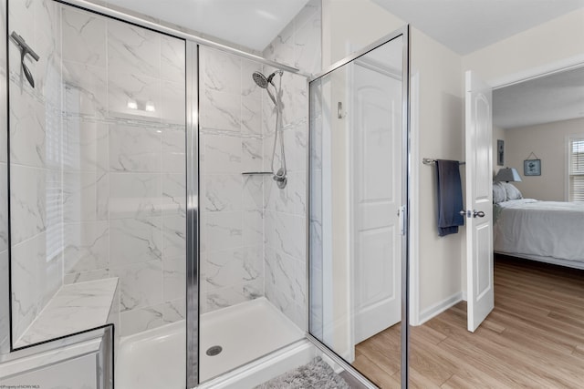 bathroom featuring hardwood / wood-style flooring and an enclosed shower