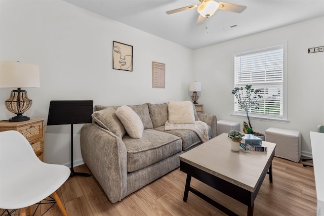 living room featuring ceiling fan and light wood-type flooring