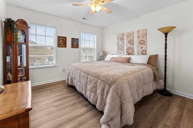 bedroom with ceiling fan and light hardwood / wood-style floors