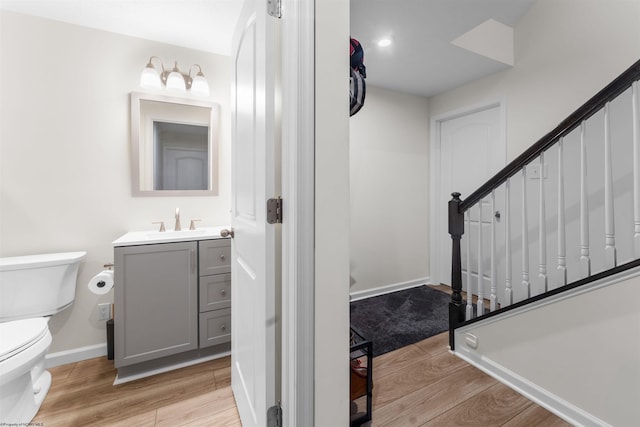 bathroom featuring vanity, hardwood / wood-style floors, and toilet