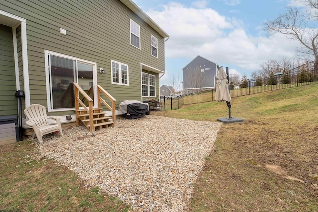 rear view of house featuring a yard