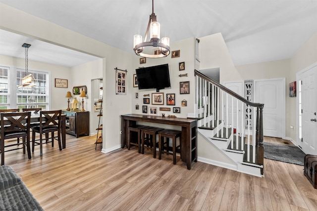 interior space with a chandelier and light wood-type flooring