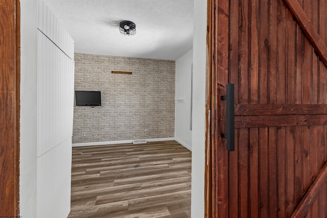 bathroom featuring hardwood / wood-style floors and a textured ceiling