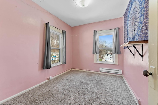 carpeted empty room featuring baseboard heating