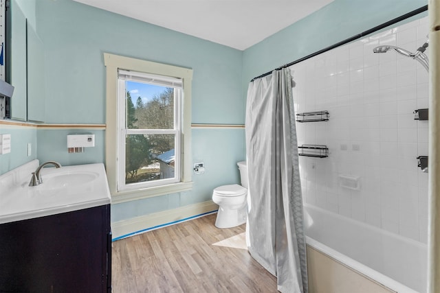 full bathroom with toilet, vanity, shower / bathtub combination with curtain, and hardwood / wood-style floors