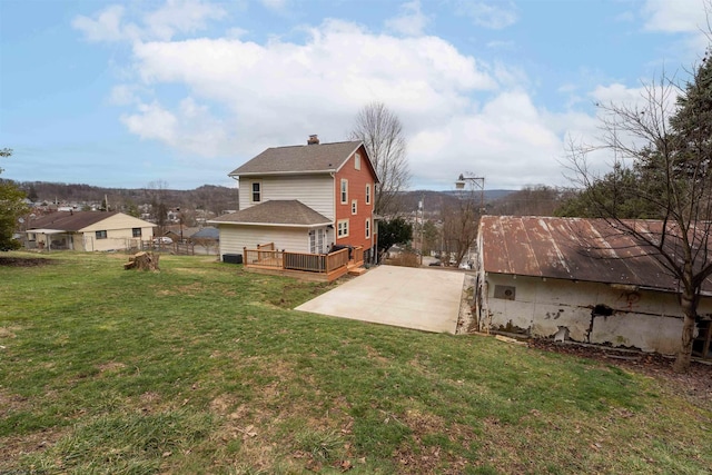 view of side of property with a yard, a patio area, and a deck