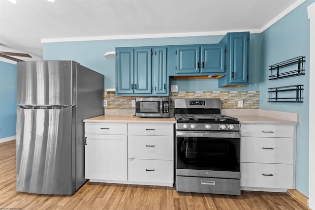 kitchen featuring ceiling fan, appliances with stainless steel finishes, white cabinetry, light hardwood / wood-style floors, and blue cabinets