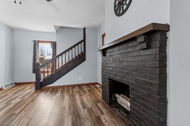 living room with hardwood / wood-style floors and a fireplace