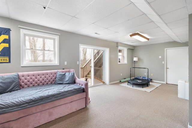 living room featuring carpet floors and a paneled ceiling