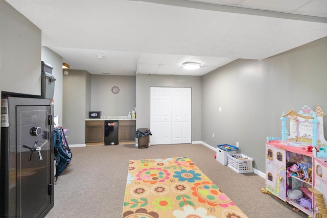 rec room featuring a paneled ceiling and carpet