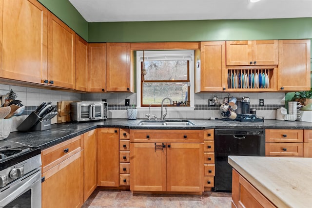 kitchen featuring backsplash, black dishwasher, sink, and stainless steel gas range