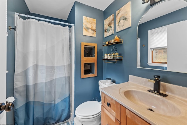 bathroom featuring vanity, curtained shower, and toilet