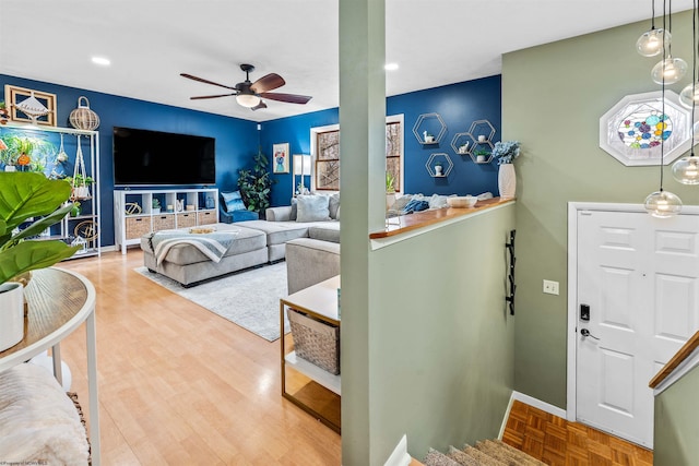 living room featuring parquet floors and ceiling fan