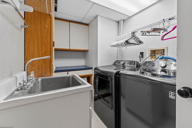 laundry room featuring cabinets, sink, and independent washer and dryer