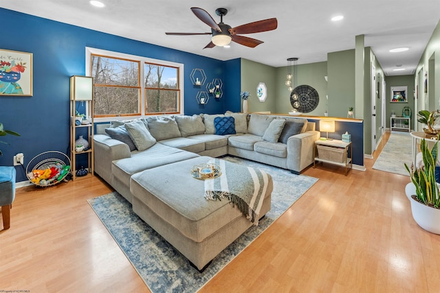 living room with hardwood / wood-style flooring and ceiling fan