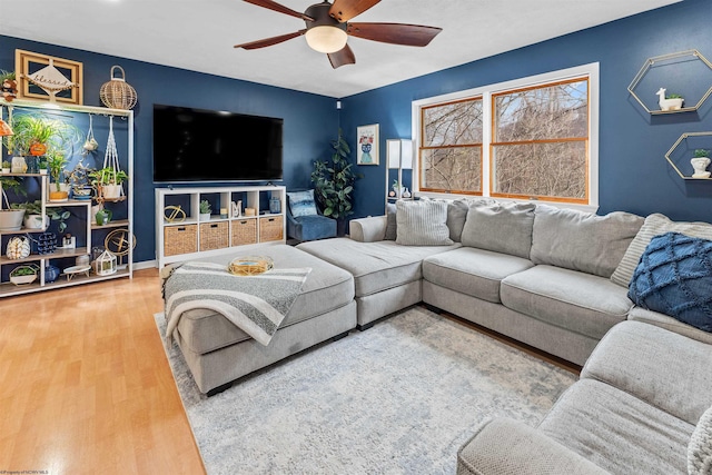 living room featuring hardwood / wood-style floors and ceiling fan