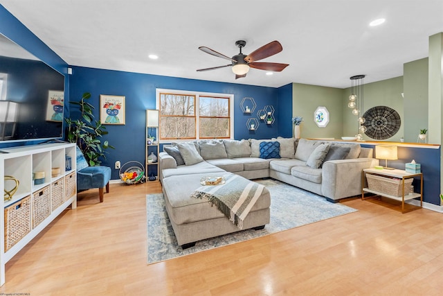 living room featuring light hardwood / wood-style floors and ceiling fan