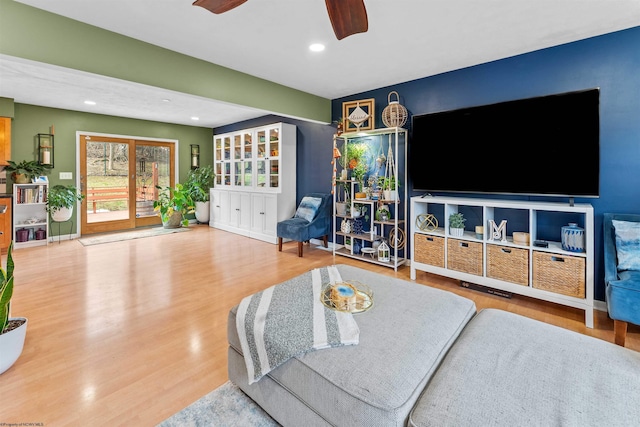 living room featuring hardwood / wood-style flooring and ceiling fan