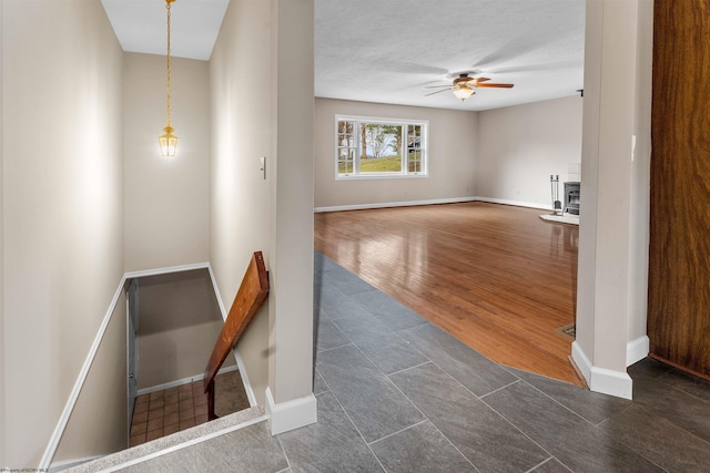 interior space with dark wood-type flooring and ceiling fan