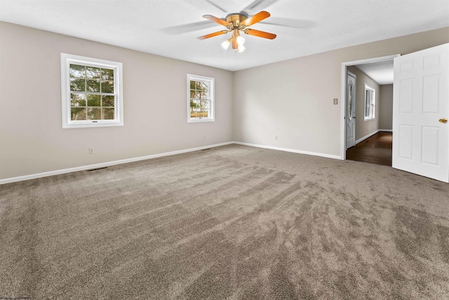 carpeted spare room featuring ceiling fan