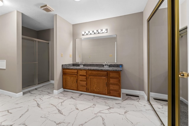 bathroom featuring vanity and an enclosed shower