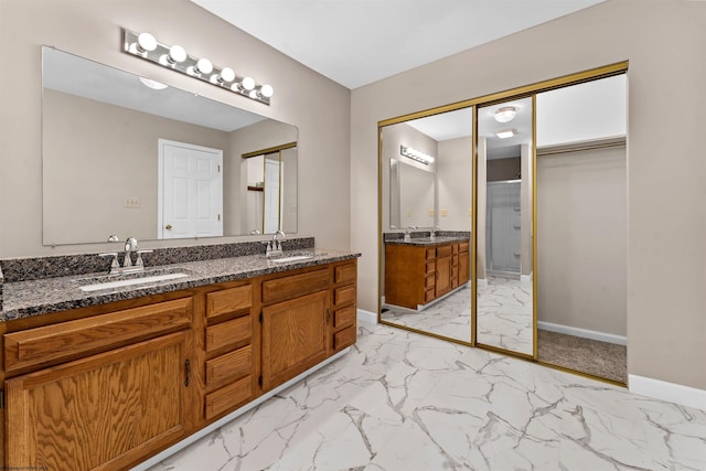 bathroom with vanity and a shower with door