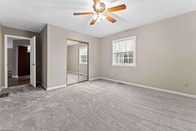 unfurnished bedroom featuring a closet, ceiling fan, and carpet flooring