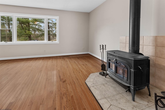 living room featuring light hardwood / wood-style floors and a wood stove