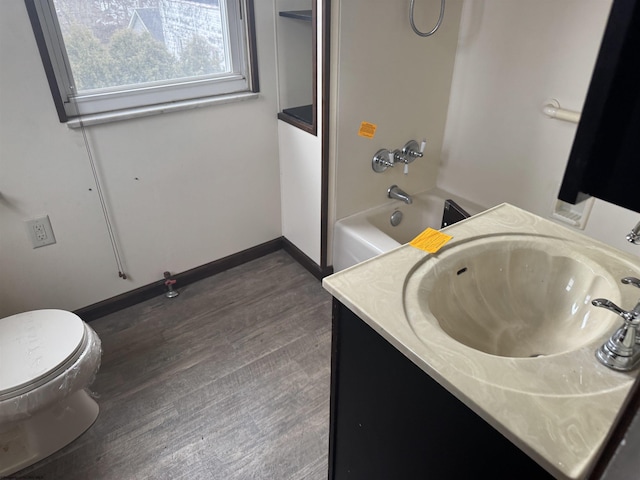 full bathroom featuring vanity, wood-type flooring, shower / tub combination, and toilet