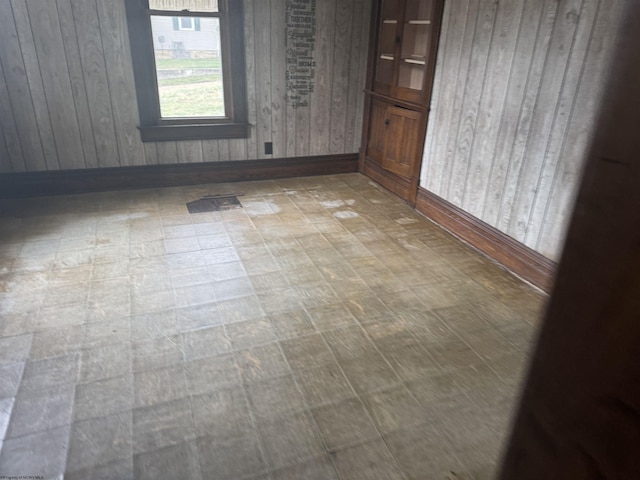 empty room featuring wood walls