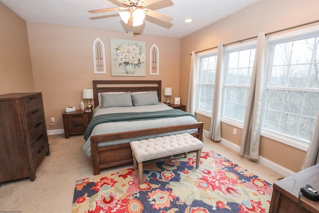 bedroom with ceiling fan and light colored carpet