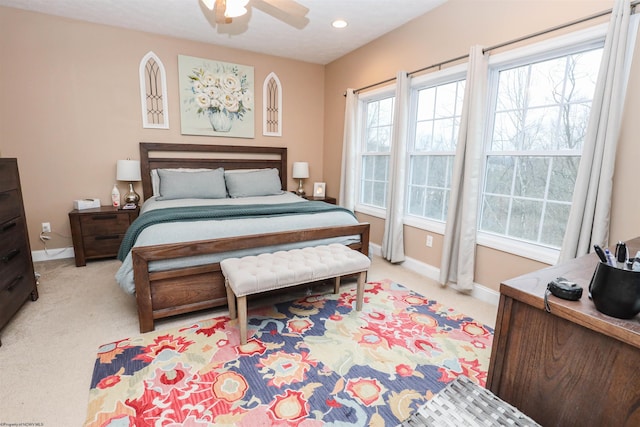 bedroom with ceiling fan and light colored carpet