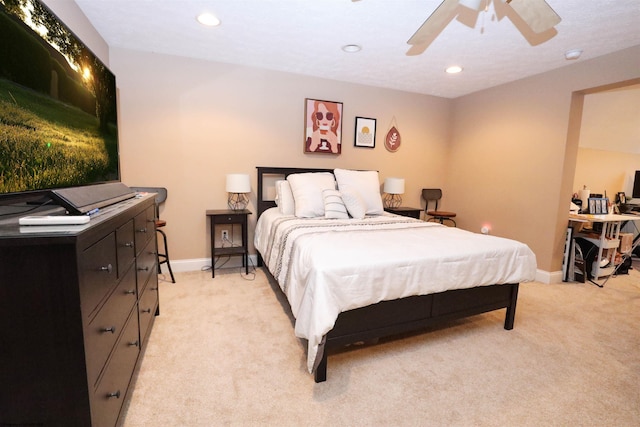 bedroom featuring light colored carpet and ceiling fan