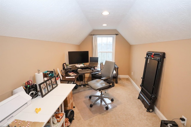 carpeted home office with vaulted ceiling and a textured ceiling