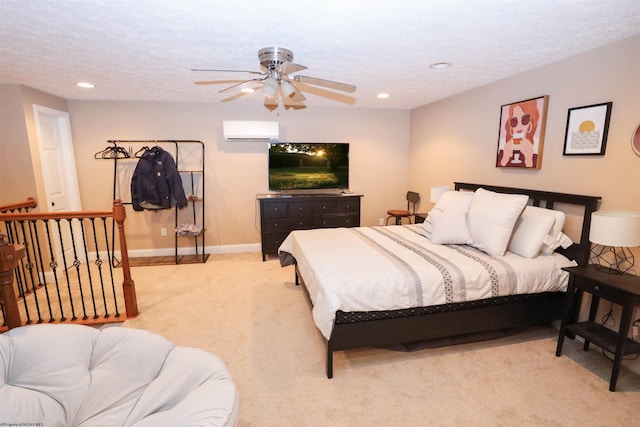 bedroom with light carpet, a wall mounted air conditioner, a textured ceiling, and ceiling fan