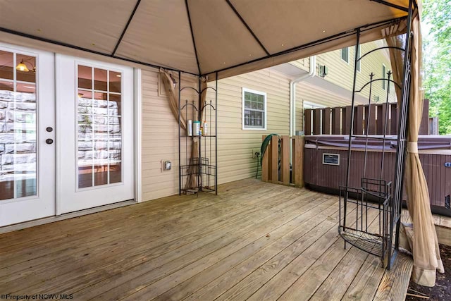 wooden deck featuring a gazebo and a hot tub