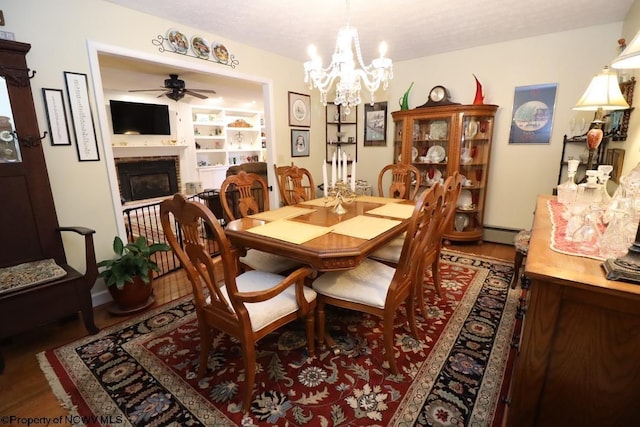 dining area featuring a baseboard radiator and ceiling fan with notable chandelier