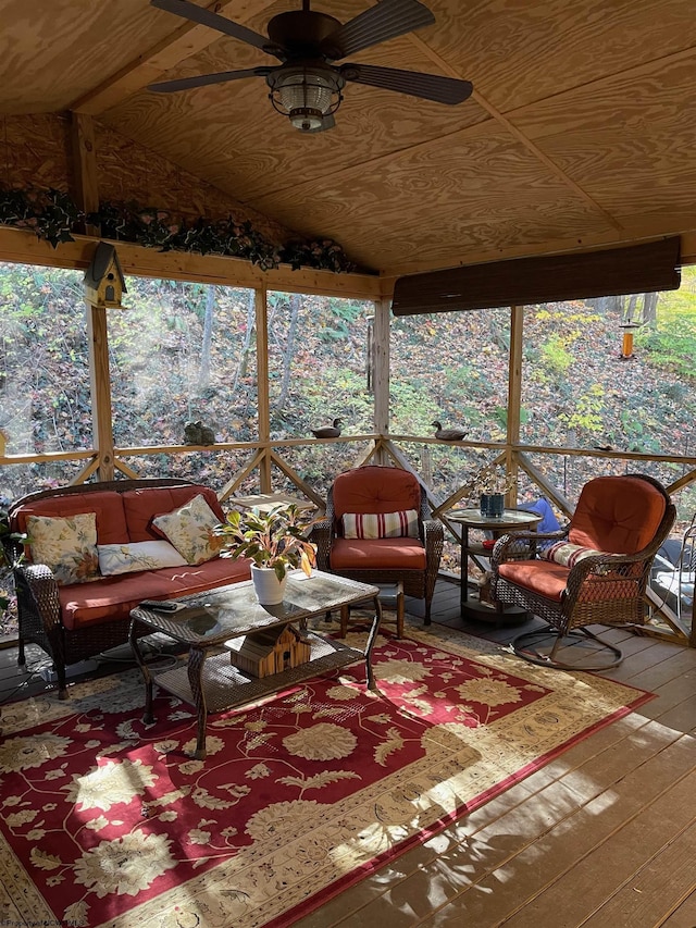 sunroom / solarium featuring wood ceiling, ceiling fan, and lofted ceiling