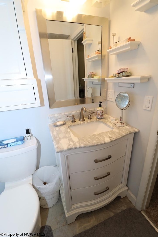 bathroom with vanity and toilet