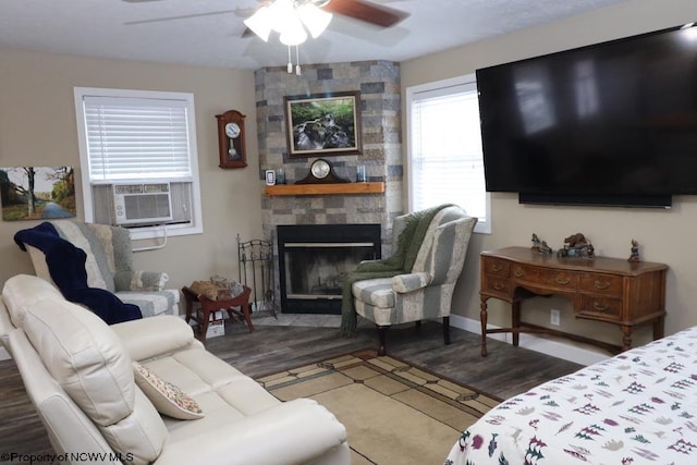 living room with dark hardwood / wood-style floors, ceiling fan, and a fireplace